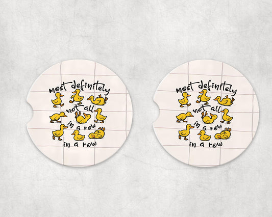 Most definitely not in a row Ceramic or Neoprene Car Coasters